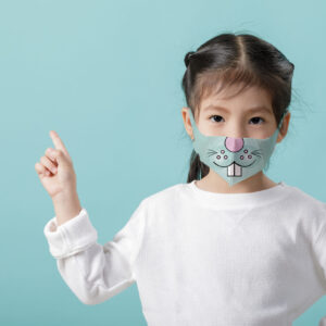 Asian little child girl wearing respirator mask to protect coron